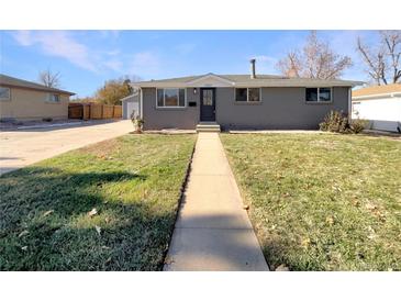 Charming ranch home with a landscaped lawn and walkway at 1059 S Saulsbury St, Lakewood, CO 80226