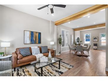 Spacious living room with hardwood floors, a leather couch, and an open floor plan at 154 W Bayaud Avenue, Denver, CO 80223