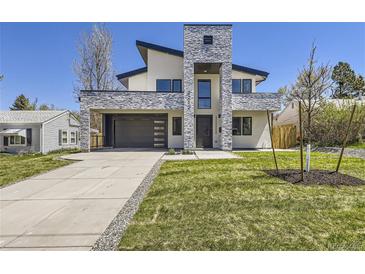 Modern two-story home with stone accents and landscaped yard at 3212 S Dahlia St, Denver, CO 80222