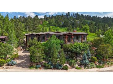 Mountain view home with stonework landscaping and large windows at 1420 Sierra Dr, Boulder, CO 80302