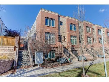 Attractive three-story townhome with brick exterior and landscaping at 2311 Decatur St, Denver, CO 80211