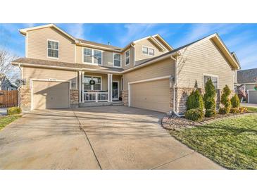 Two-story house with a three-car garage and landscaped front yard at 6650 Sunburst Ave, Firestone, CO 80504