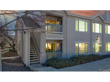 Exterior view of a light beige townhouse with stairs leading to the entrance at 1120 Opal St # 104, Broomfield, CO 80020