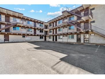 Aerial showing the apartment building and its parking lot at 590 N Logan St # 210, Denver, CO 80203