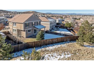 Two-story home with fenced backyard, patio, and mountain views at 2090 Candleglow St, Castle Rock, CO 80109