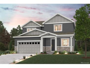 Two-story home with gray siding, light gray garage door, and landscaping at 4326 Canyata Dr, Elizabeth, CO 80107