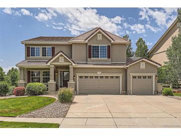 Two story house with three car garage and manicured lawn at 4766 Longs Ct, Broomfield, CO 80023