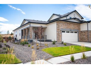 Modern two-story home with stone accents and landscaped front yard at 17392 W 93Rd Pl, Arvada, CO 80007