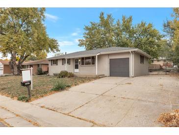 Ranch style home with attached garage and mature landscaping at 8467 W 62 Pl, Arvada, CO 80004