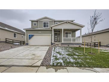 Two-story home with gray siding and a covered porch at 5685 Wayfarer Cir, Firestone, CO 80504