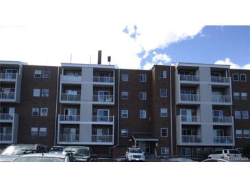 Brick apartment building with balconies and ample parking at 1150 Golden Cir # 201, Golden, CO 80401