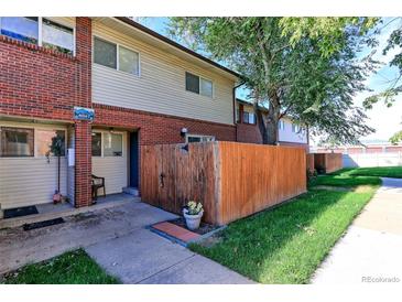 Brick townhouse with wooden fence and small yard at 8047 Wolff St # F, Westminster, CO 80031