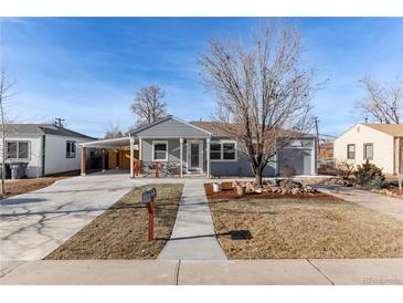 Ranch style home with gray siding, landscaped yard, and driveway at 1925 S Hazel Ct, Denver, CO 80219