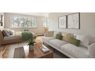 Studio apartment living room with sofa, bed, and wood floors at 969 S Pearl St # 204, Denver, CO 80209
