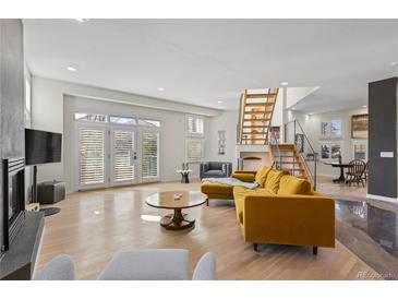 Spacious living area with hardwood floors, fireplace and access to backyard at 175 Harrison St, Denver, CO 80206