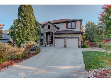 Two-story house with stone accents, red shutters, and a three-car garage at 5033 Silver Feather Way, Broomfield, CO 80023