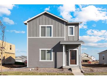 Two-story gray townhome with front yard at 2971 Pershing St, Strasburg, CO 80136