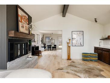 Bright living room with a fireplace and hardwood floors at 436 Devinney Ct, Golden, CO 80401