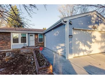 Ranch style home with brick and siding exterior, attached garage, and landscaping at 17863 E Prentice Dr, Centennial, CO 80015