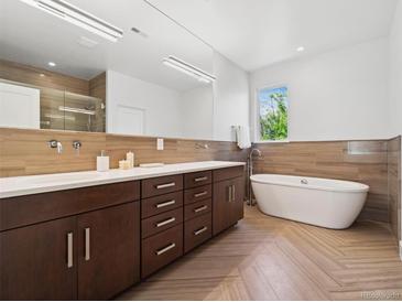 Modern bathroom with double vanity, soaking tub, and walk-in shower at 3100 E 17Th Ave, Denver, CO 80206