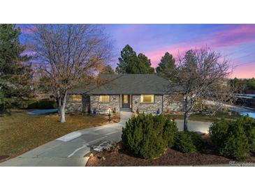 Brick ranch home with landscaped yard and large driveway at 6690 S Sheridan Blvd, Littleton, CO 80123