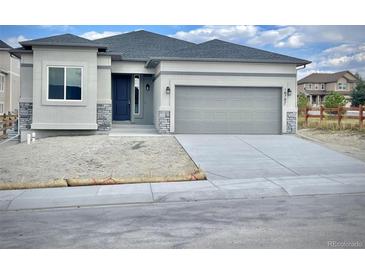 New construction home with gray siding, two-car garage, and landscaped front yard at 16707 Greyhawk Dr, Monument, CO 80132