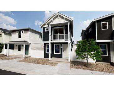 Two-story home with dark exterior, balcony, and light-colored accents at , Commerce City, CO 80022