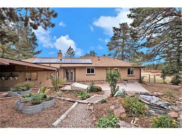 Landscaped backyard with pond and garden at 656 N Russellville Rd, Franktown, CO 80116