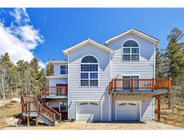 Two-story home with double garage and deck at 11770 Leavenworth Dr, Conifer, CO 80433