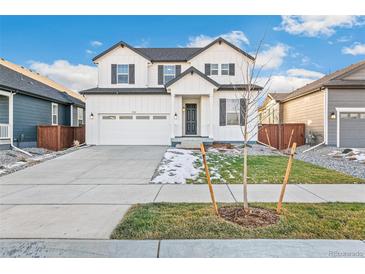 Charming two-story home with white siding, black trim, and a welcoming front porch at 1562 Farmstead St, Brighton, CO 80601