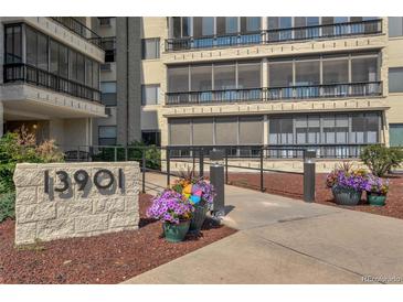 Attractive building exterior with landscaping and walkway at 13901 E Marina Dr # 105, Aurora, CO 80014