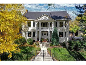 Grand two-story home with columns and landscaping at 4101 E 17Th Avenue Pkwy, Denver, CO 80220