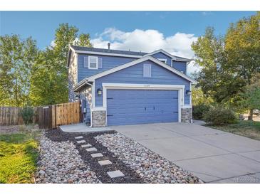 Two-story home with a blue exterior and stone accents at 5109 S Malta Way, Centennial, CO 80015