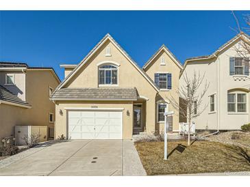 Tan two-story house with a white door and garage at 15535 W Auburn Ave, Lakewood, CO 80228