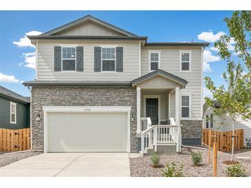 Two-story house with stone accents and a two-car garage at 13332 E 110Th Way, Commerce City, CO 80022