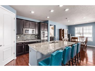 Modern kitchen with stainless steel appliances and granite countertops at 7426 E 148Th Pl, Thornton, CO 80602