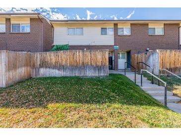 Front view of townhouse with steps and wooden fence at 8051 Wolff St # C, Westminster, CO 80031