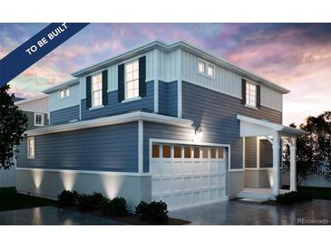 Two-story home with blue siding, white trim, and a two-car garage at , Aurora, CO 80019