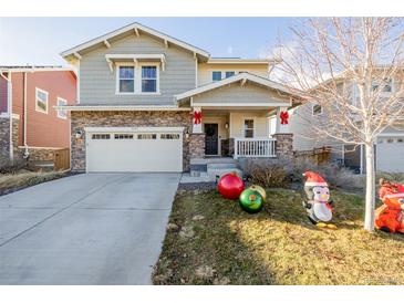 Two-story house with attached garage and landscaped front yard at 5957 N Orleans St, Aurora, CO 80019