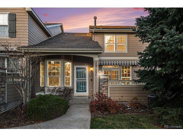 Two-story townhome with landscaped yard and a covered entryway at 10123 Grove Loop # C, Westminster, CO 80031