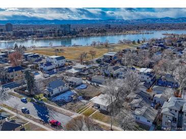 Aerial showing property, lake, and distant city skyline at 2031 Meade St, Denver, CO 80211