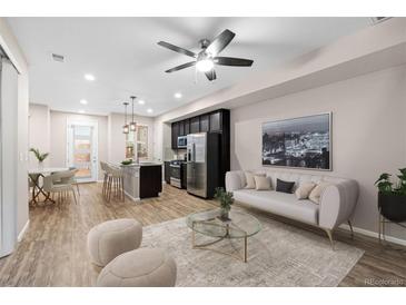 Open living room with a comfy sofa and a modern coffee table at 23630 E 5Th Pl, Aurora, CO 80018