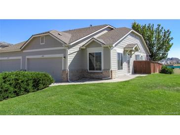 Exterior view of a two car garage and well maintained lawn at 4462 S Jebel Ct, Centennial, CO 80015