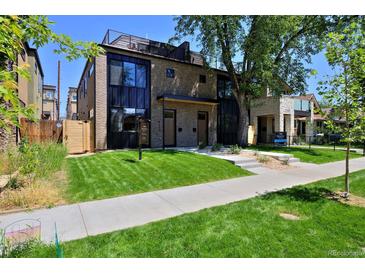 Modern two-story home with a landscaped front yard and a paved walkway at 3916 N Raleigh St, Denver, CO 80212
