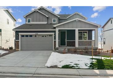 Two-story home with gray siding, attached garage, and landscaping at 4226 Canyata Dr, Elizabeth, CO 80107