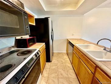 Bright kitchen features ample counter space, modern appliances, and a double sink at 16001 E Alaska Pl # 7, Aurora, CO 80017