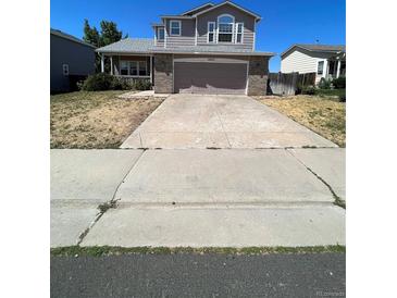 Two-story house with a brick front and attached garage at 2217 S Telluride Ct, Aurora, CO 80013
