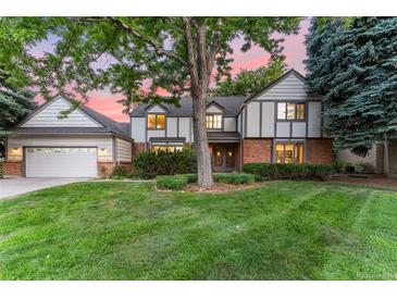 Two-story home with attached garage and manicured lawn at 5977 S Zenobia Ct, Littleton, CO 80123