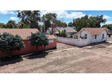 Exterior view of a commercial property with two buildings and a large parking area at 480 N 6Th Ave, Brighton, CO 80601