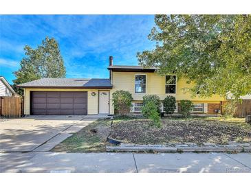 House exterior, two-story yellow siding, brown garage door at 12206 W Quinn Dr, Morrison, CO 80465